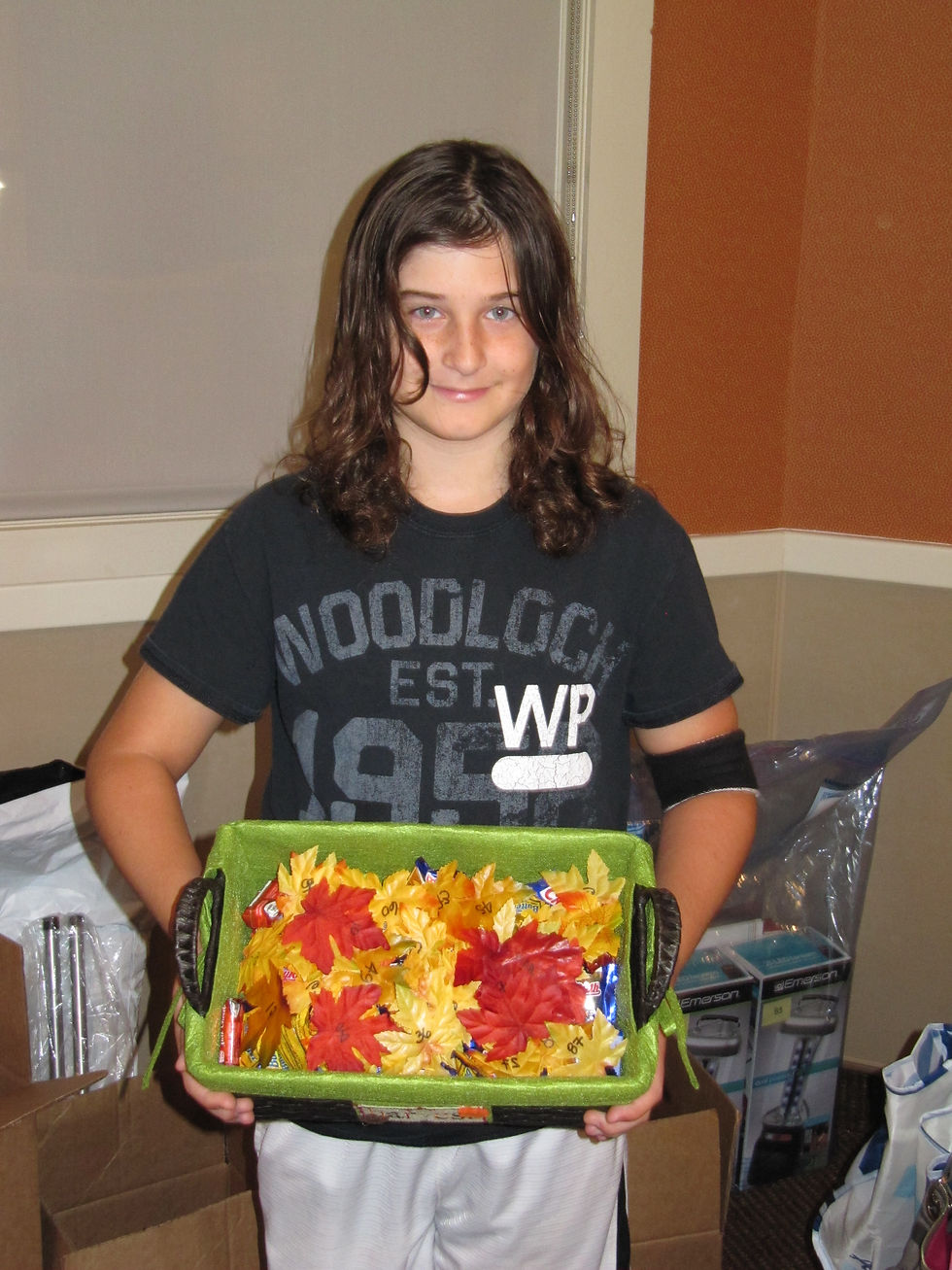 Young volunteer for Adopt A Senior helping with the Fall Fundraiser
