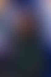 close-up of woman on a panel speaking into a microphone