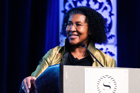 black lady speaking at a podium