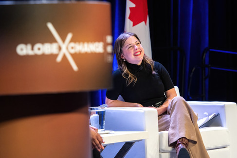smiling woman on stage with branding