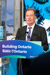 close-up of Minister George Pirie speaking at a press conference