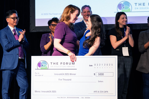 woman receiving a big cheque on stage