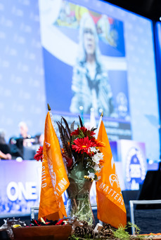 Orange Indigenous flags at an event