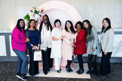 group shot in front of Usana display
