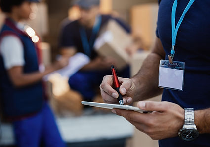 close-up-of-delivery-man-using-digital-tablet-2024-12-13-16-46-42-utc.jpg