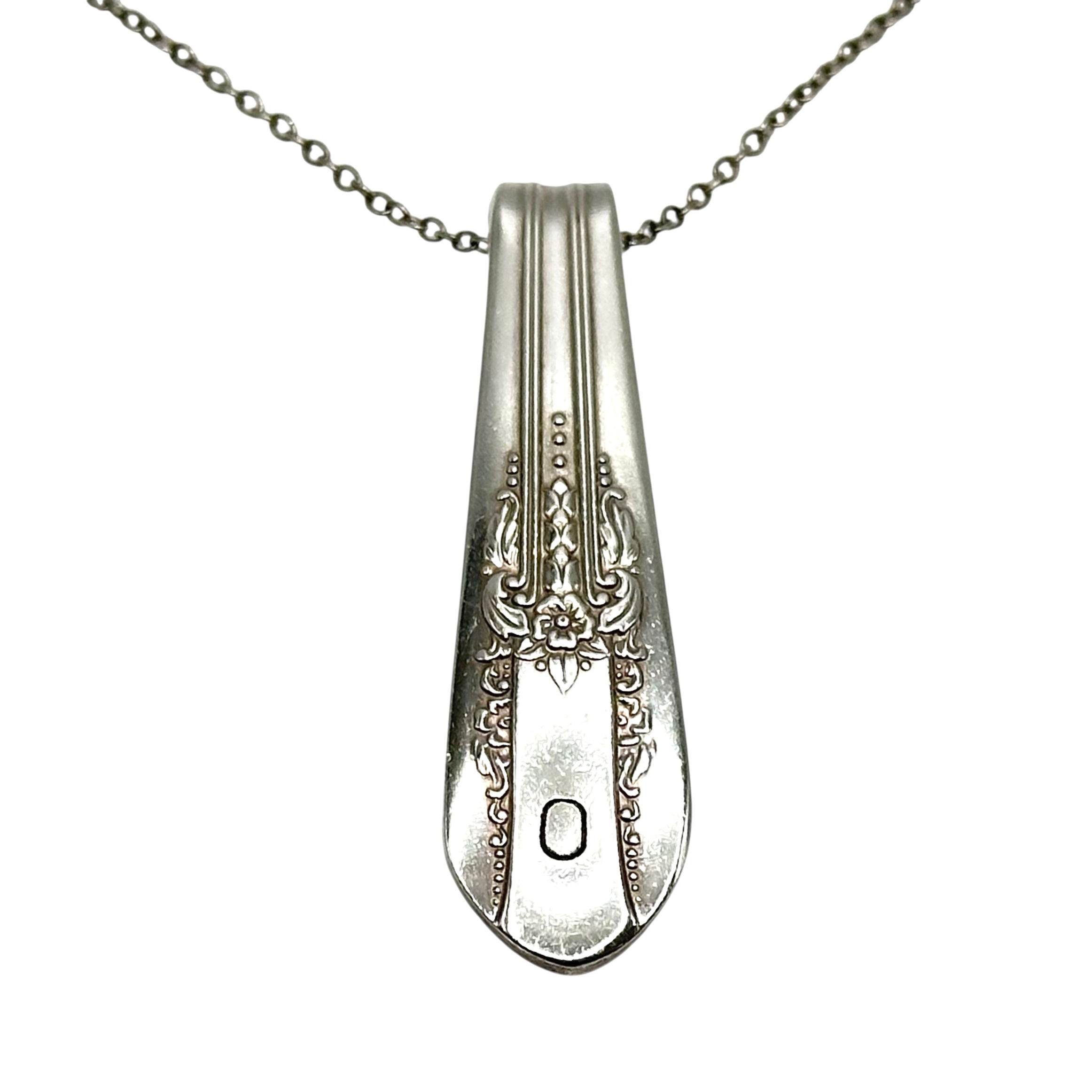 (O) Monogrammed necklace.