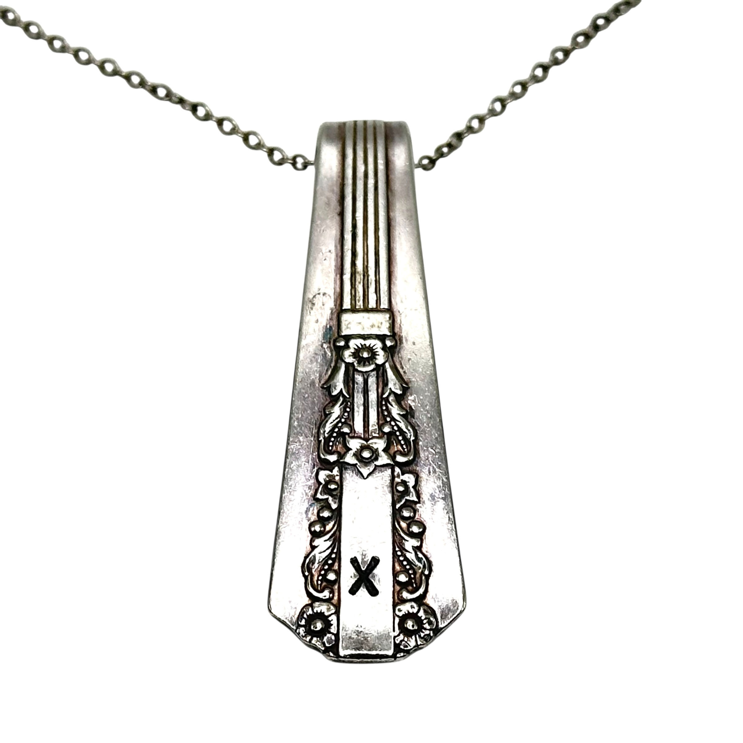 (X) Monogrammed necklace.
