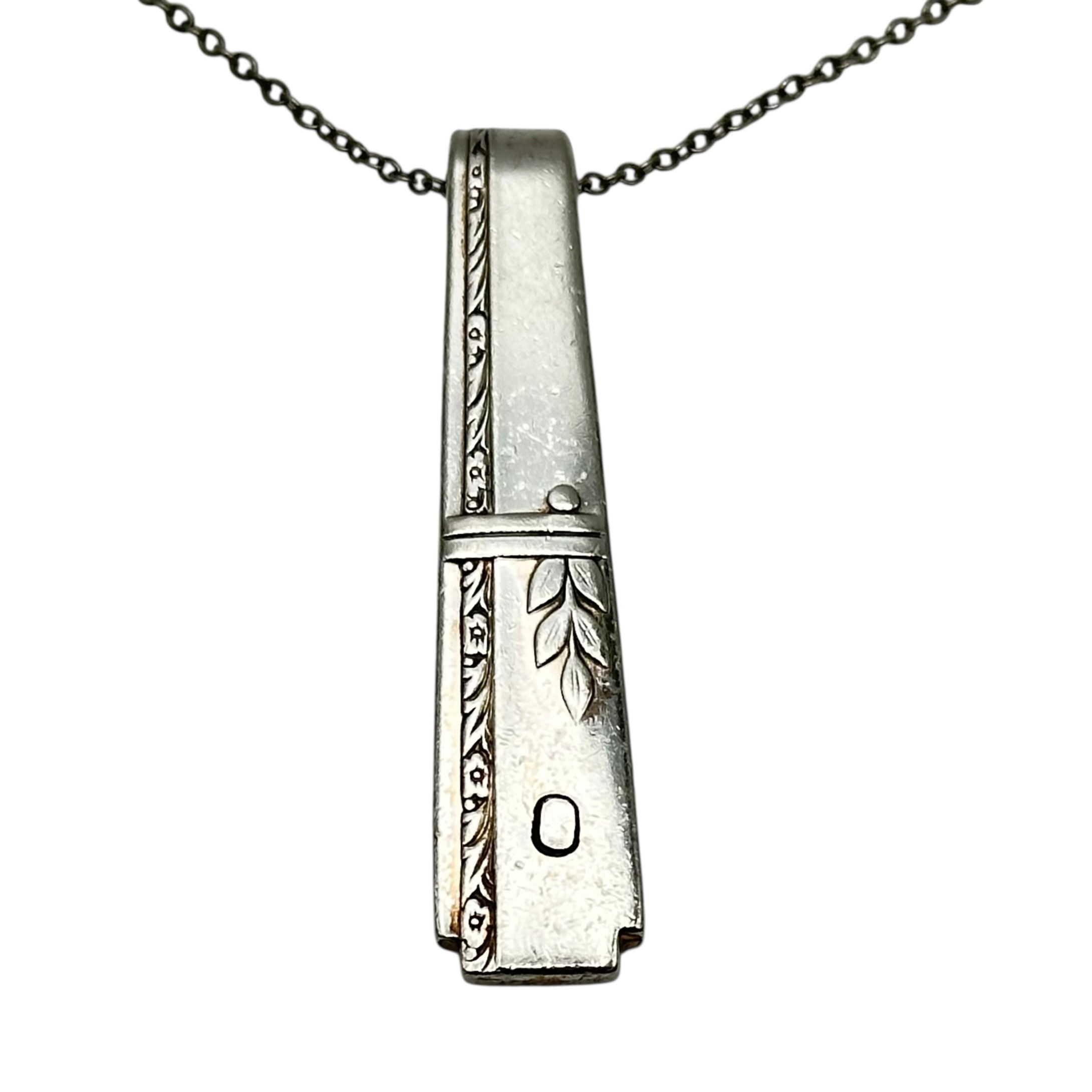 (O) Monogrammed necklace.