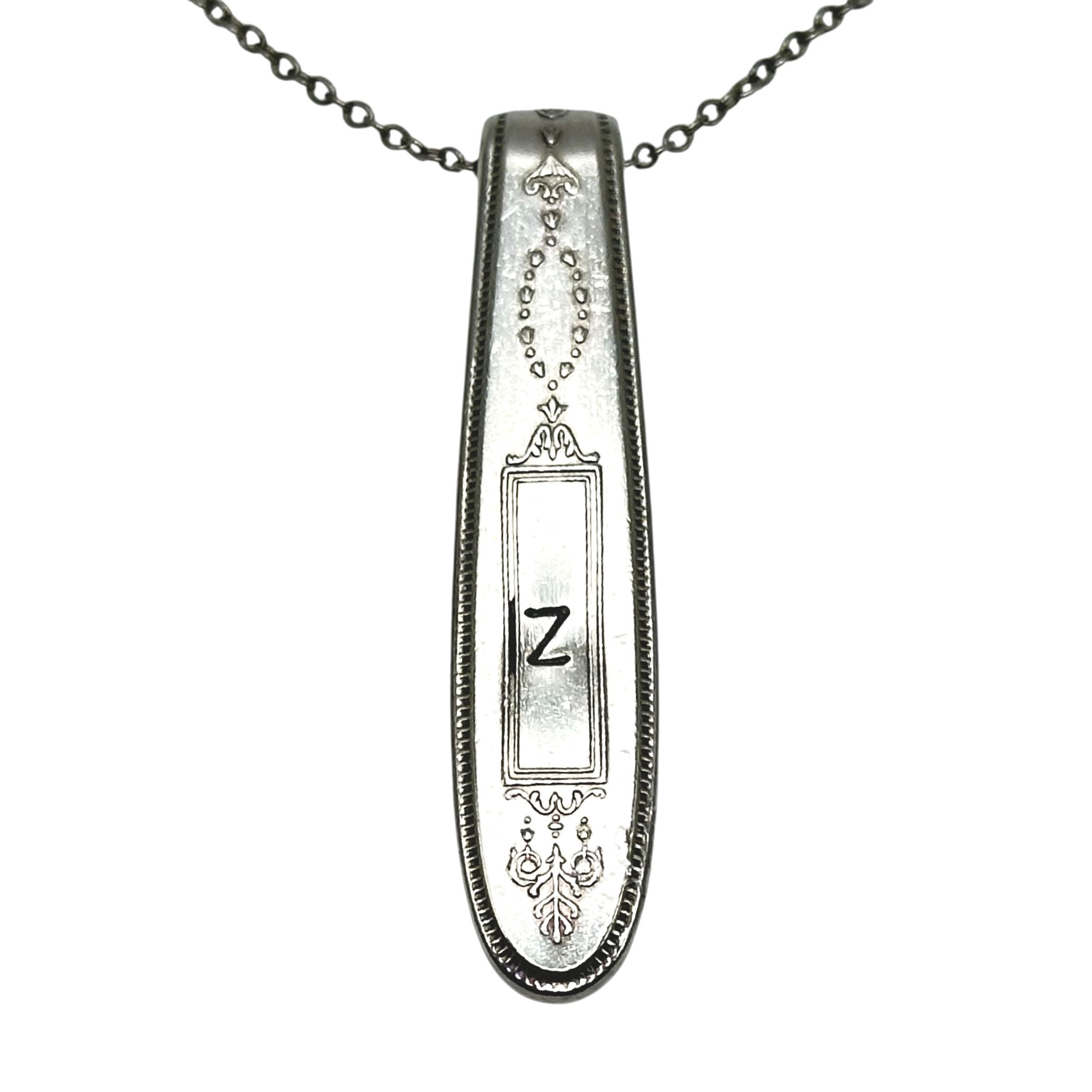 (Z) Monogrammed necklace.