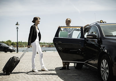 businessman opening car door for female colleague