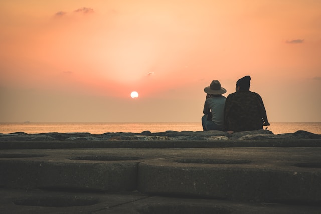 Couple sitting together at sunset, reflecting on connection and taking time to build trust in dating