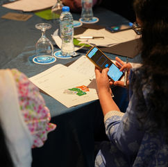 Grid Society live workshop sessions in London and Dubai showing participants engaging with the Grid framework, the “Your Grid Journey” visual and structured inner work exercises.