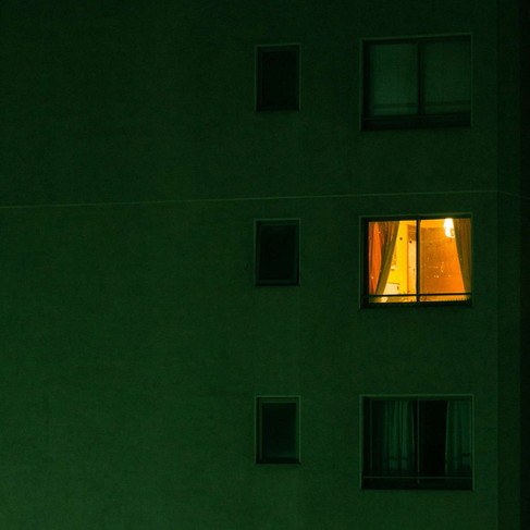 4am thinking - Illuminated apartment window at night representing overthinking, late-night reflection, and the comparison voice.