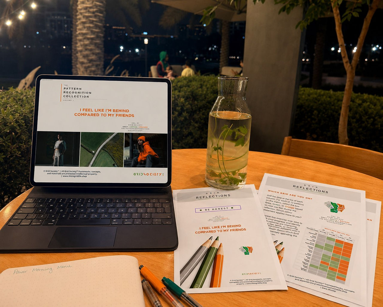 Grid Society Volume 1 comparison workbook displayed on a laptop beside printed Pattern Recognition reflection pages.