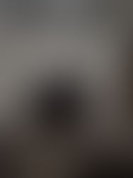 Woman sitting on a bed in the morning using a laptop, reflecting early in the day, representing overthinking and the need for mental clarity