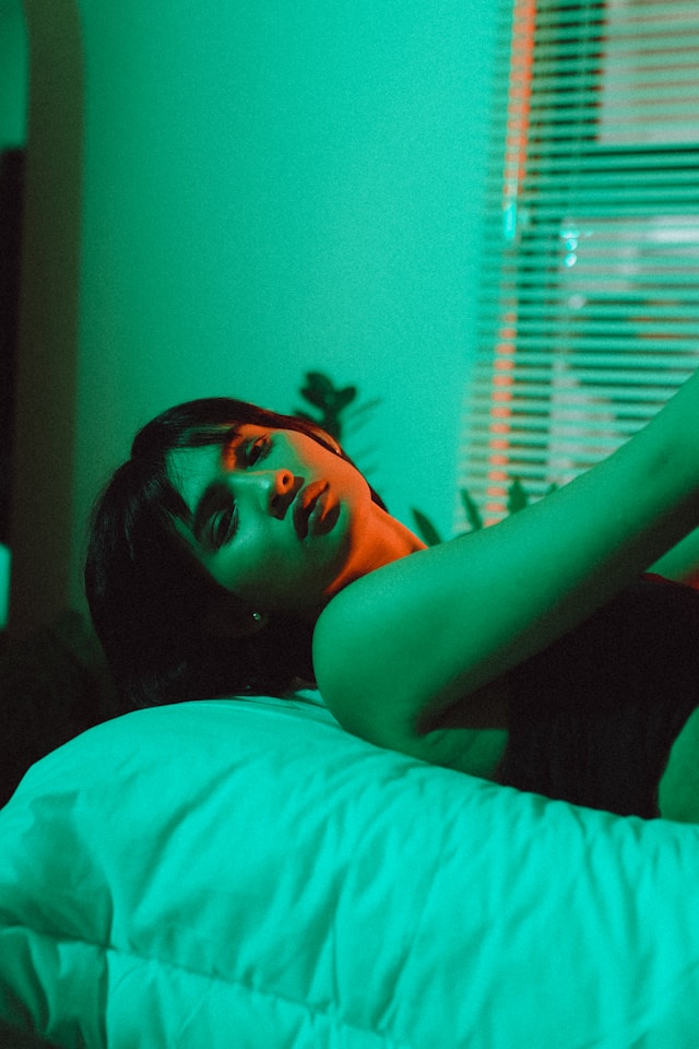 Overthinking after a date at 4am, woman lying awake in bed replaying what she said