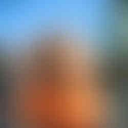 woman in orange representing confidence, clarity and winning after learning to navigate your thoughts