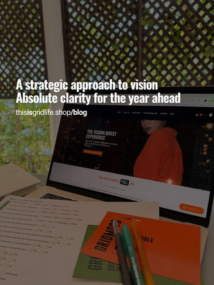 Vision Quest Experience workspace with strategic vision workbook, pens, and laptop showing the Vision Quest online workshop, focused on goals and direction for the year ahead.