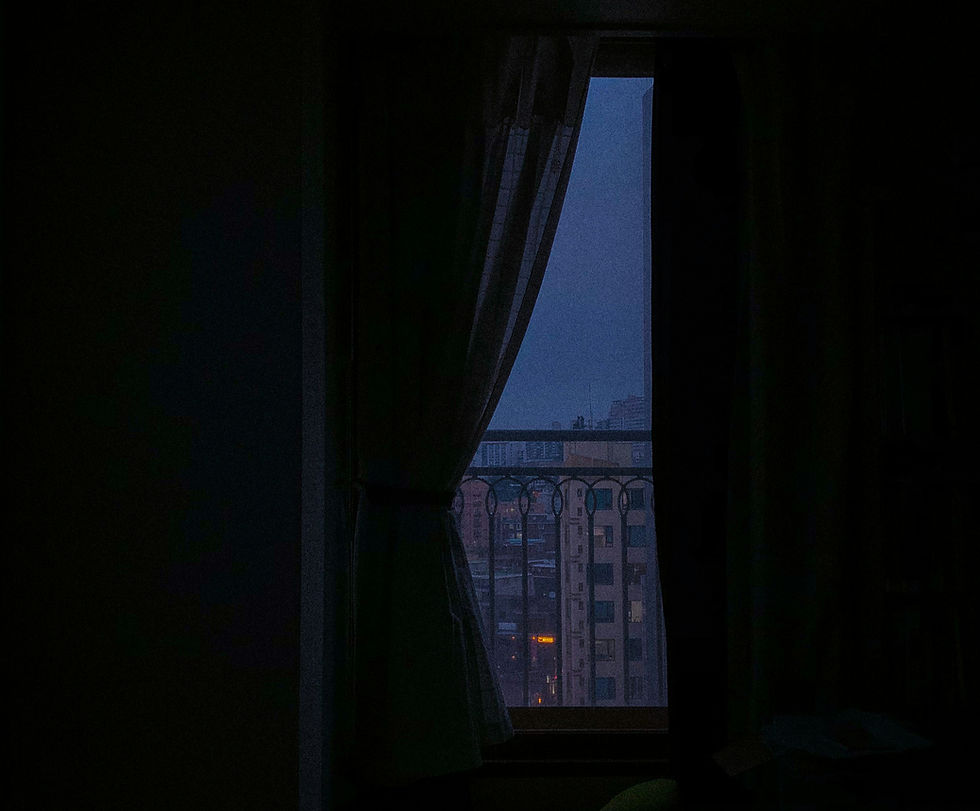 4am dark bedroom window overlooking quiet city buildings at dawn, reflecting early morning overthinking and racing mind before sunrise.