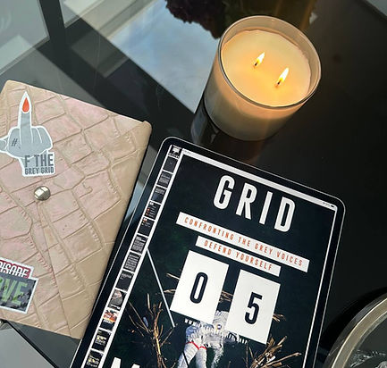 Grid Society journaling mission workbook beside a candle and reflective materials, representing immersive self-development, deep inner work, and structured daily journaling for personal growth and emotional awareness.