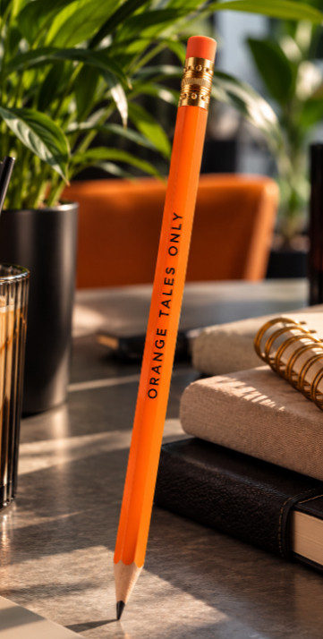 Orange Tales Only pencil beside a journal, representing creative journalling, rewriting negative thoughts and moving beyond repeated mistakes.