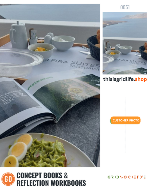 Flat lay of Grid Society concept book open on a breakfast table overlooking the sea in Santorini, with avocado toast and boiled eggs beside it.