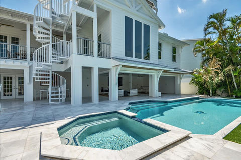 Modern white beach house with pool and spiral staircase