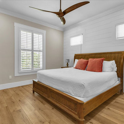 Modern bedroom with wooden furniture and shiplap wall