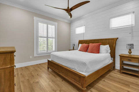 Modern bedroom with wooden furniture and shiplap wall