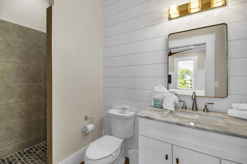 Modern bathroom with white shiplap walls and walk-in shower