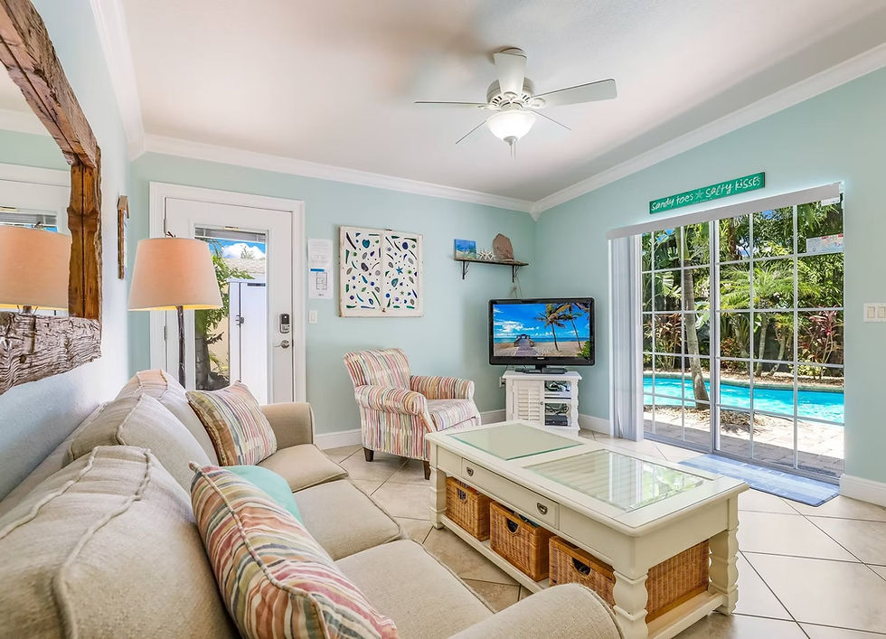 Comfortable living room with sofa, TV, and pool view