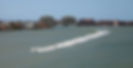 26489656_skyline-in-the-background-as-a-group-of-jet-skies-zip-along-the.jpg