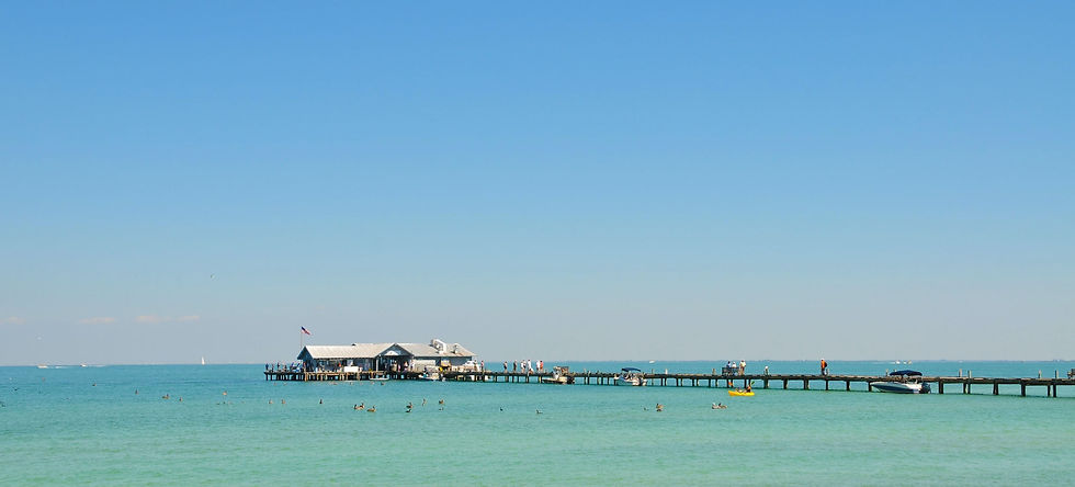 Long pier with building over clear turquoise water