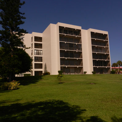 Portobello multi-story condos with balconies, lawn, and trees