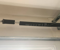 Garage door stuck halfway open due to broken torsion spring