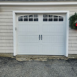 White carriage-style garage door installation with windows in MA