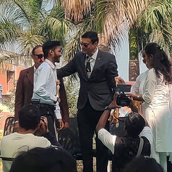 Close-up of Aviraj Kamble receiving felicitation award from college authorities.