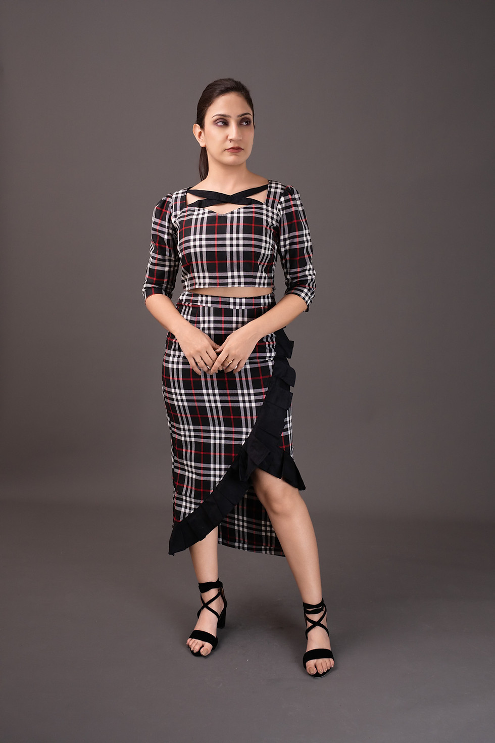 Woman in plaid top with cut-out and ruffled skirt