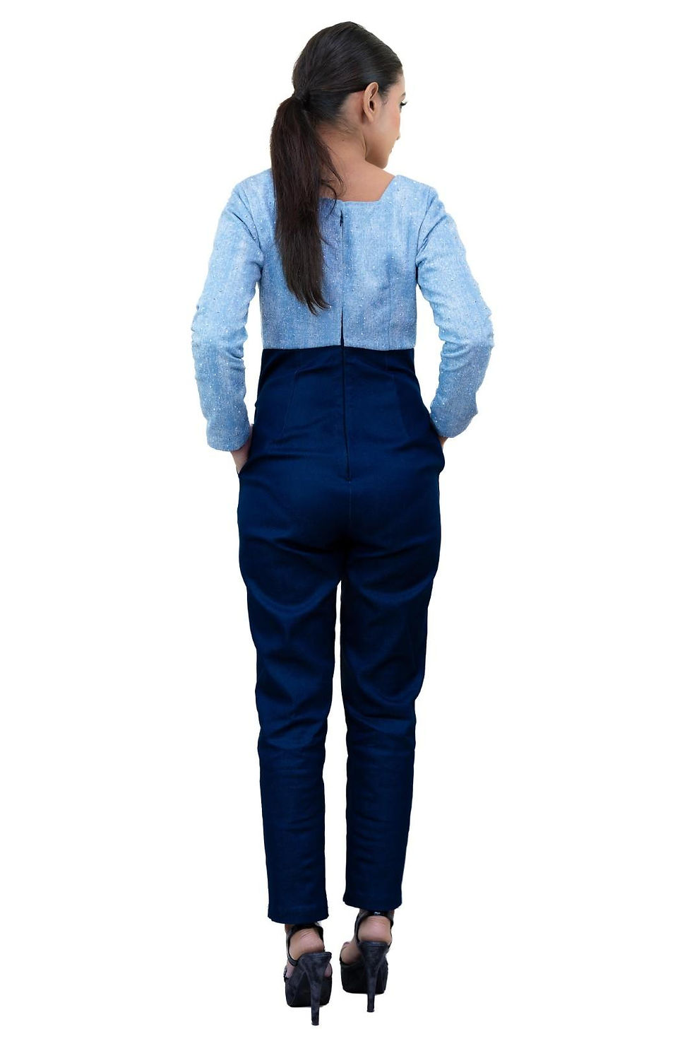 Thumbnail: Back view of woman wearing light blue top and dark blue trousers