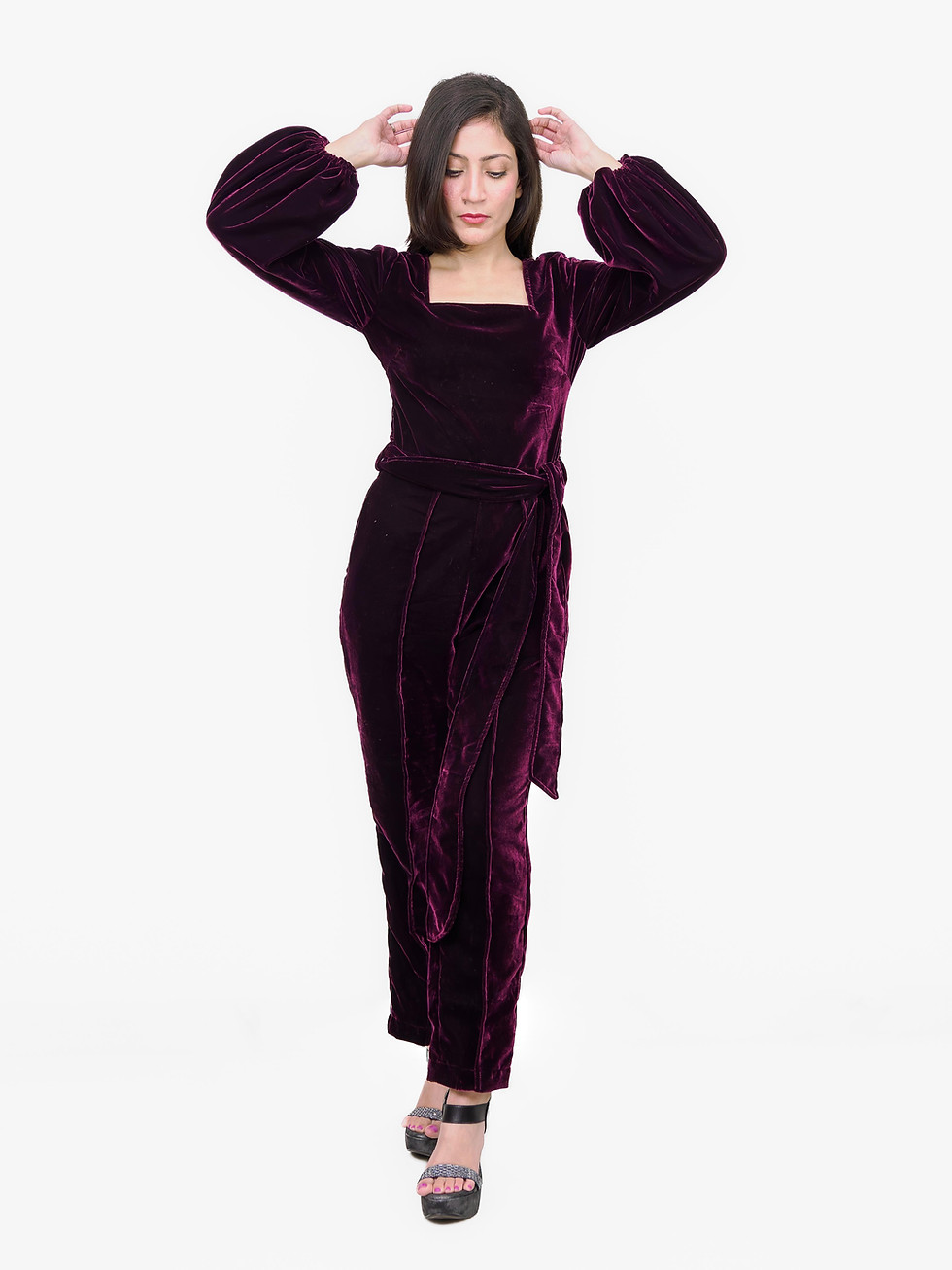 Woman in a dark purple velvet jumpsuit