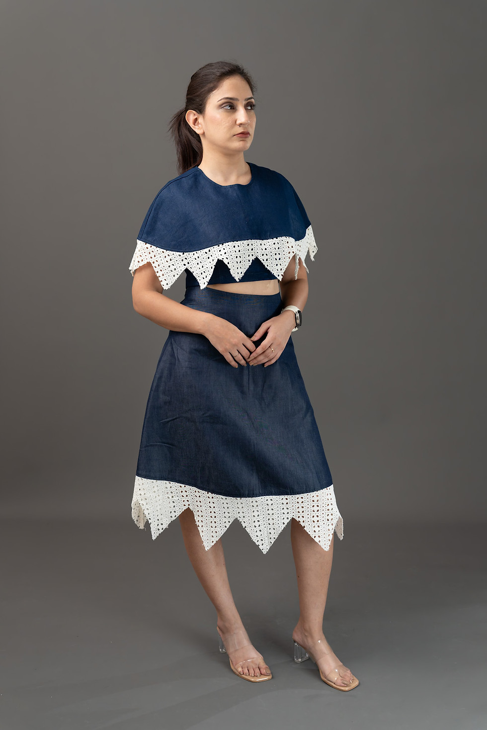 Woman in dark blue two-piece outfit with white jagged trim