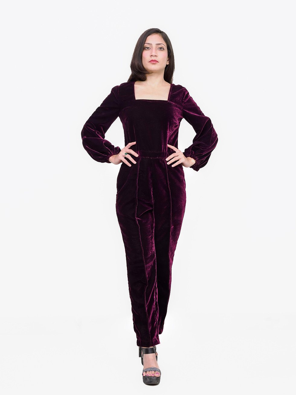 Woman in plum velvet jumpsuit with square neckline