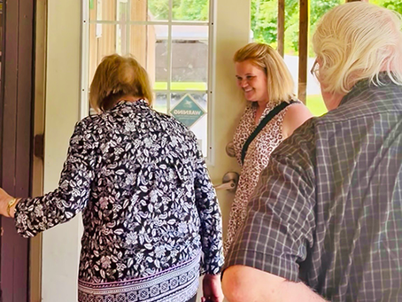 Candi holds the door for Community Store shoppers