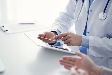 doctor-patient-sitting-table-clinic-focus-is-female-physician-s-hands-using-tablet-compute