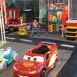 Outdoor play firehouse and ride-on Lightning McQueen car
