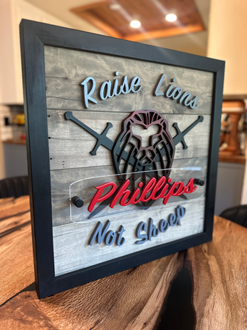 custom sign made for previous client with their last name and a lion with swords