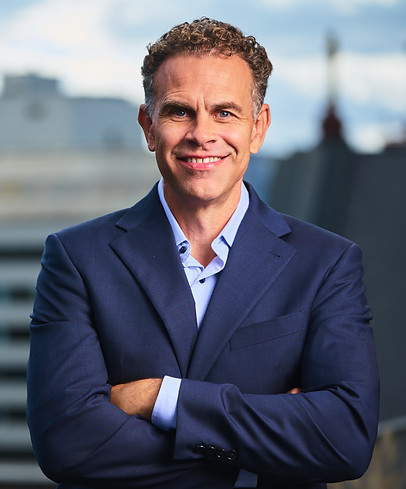 headshot arms folded - cityscape.jpg