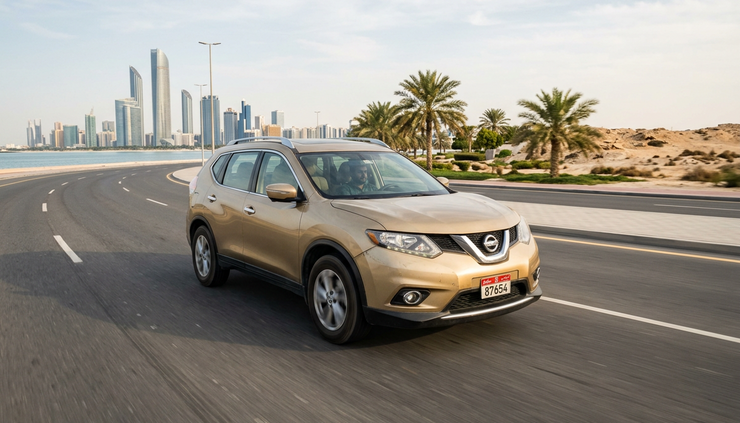 Wide-angle view of a used Nissan crossover being test driven on an Abu Dhabi road