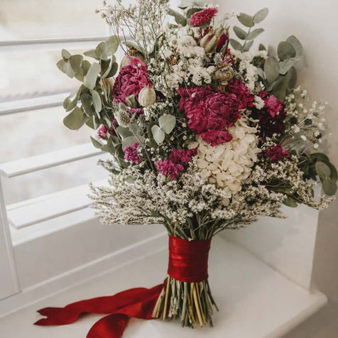 Burgundy wedding flowers with dried flowers.