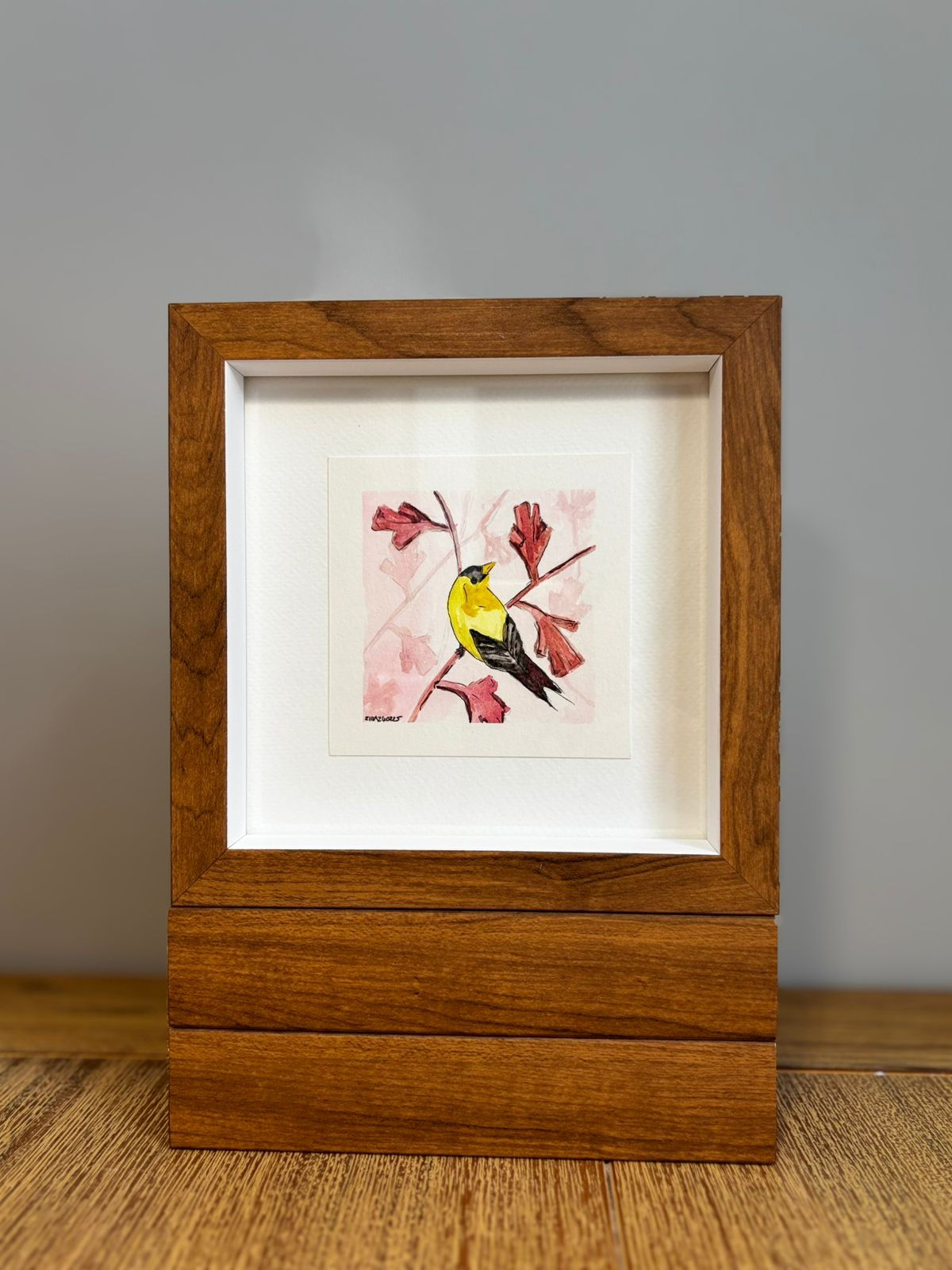 Yellow Bird on pink leaves